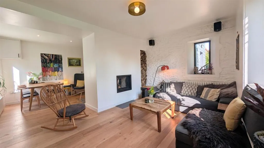 A living room filled with furniture and a fire place.