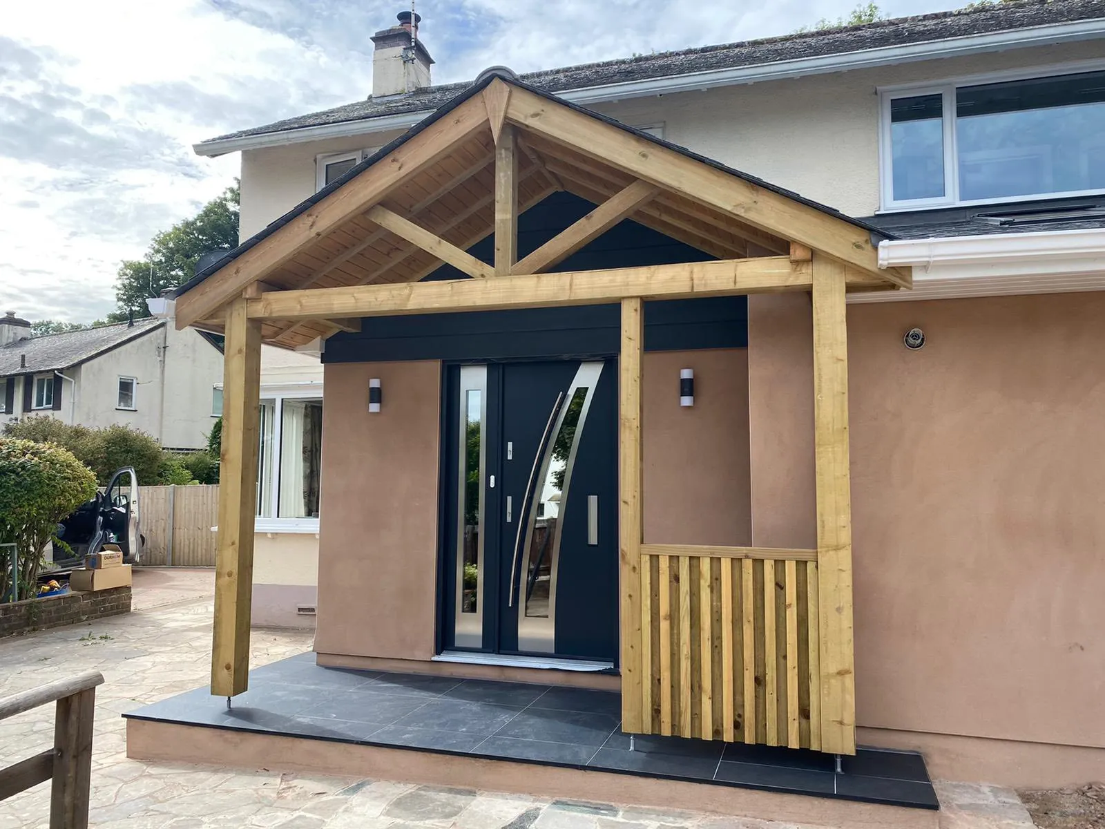 A house with a wooden porch and a black door.