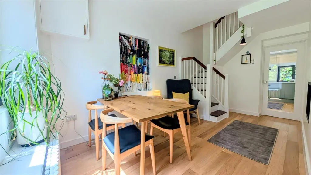 A dining room with a wooden table and blue chairs.